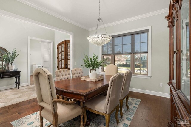 8901 Salt Grass Dr, Pensacola, FL 32526 - dining area with dark wood-style floors, a notable chandelier, ornamental molding, and baseboards
