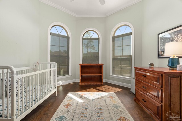 8901 Salt Grass Dr, Pensacola, FL 32526 - bedroom featuring dark wood-type flooring, ornamental molding, a ceiling fan, a crib, and baseboards