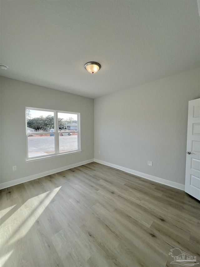 spare room with light hardwood / wood-style floors