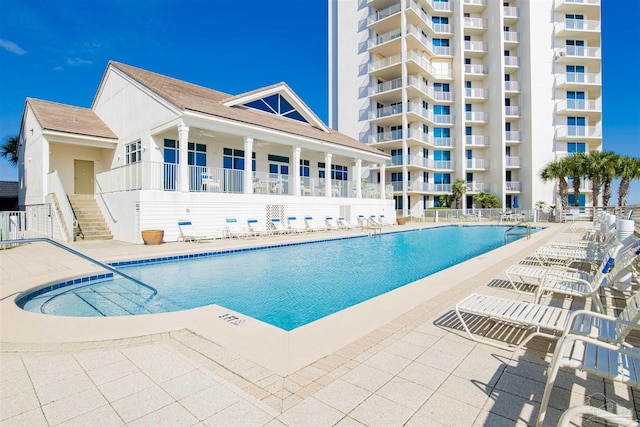 pool featuring a patio and stairway