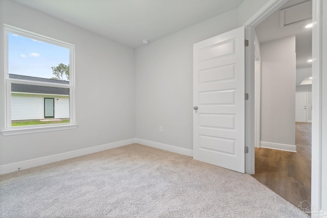 carpeted spare room featuring a healthy amount of sunlight