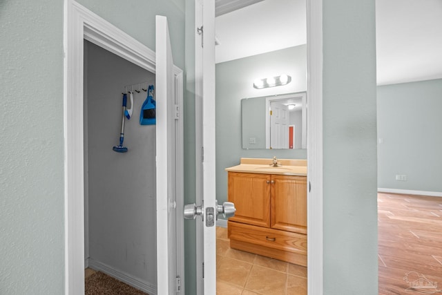 bathroom featuring tile patterned flooring, vanity, and baseboards