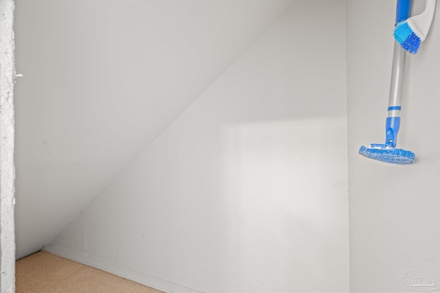 bonus room with carpet floors and vaulted ceiling