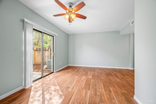 empty room with light wood-style floors, visible vents, baseboards, and a ceiling fan
