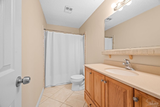 bathroom featuring visible vents, toilet, a textured ceiling, vanity, and tile patterned flooring