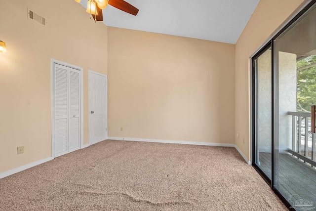 unfurnished bedroom featuring vaulted ceiling, carpet flooring, visible vents, and baseboards