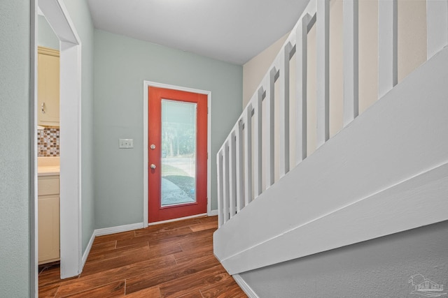 foyer featuring stairway, wood finished floors, and baseboards