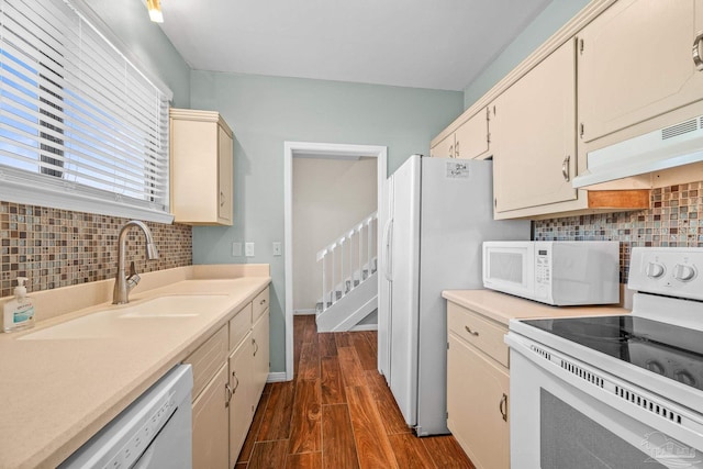 kitchen with light countertops, white appliances, dark wood-style flooring, and under cabinet range hood