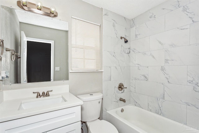 full bathroom with toilet, tiled shower / bath combo, vanity, and a textured ceiling