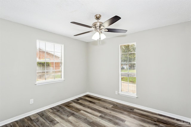 spare room with ceiling fan, dark hardwood / wood-style flooring, and a textured ceiling