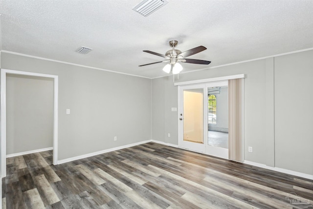 unfurnished room with a textured ceiling, ceiling fan, ornamental molding, and dark hardwood / wood-style flooring