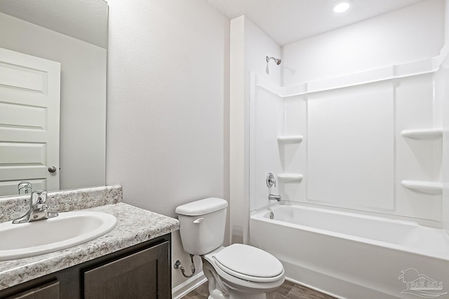 5805 Guinevere Ln, Milton, FL 32583 - full bathroom featuring toilet, wood finished floors, vanity, and shower / washtub combination