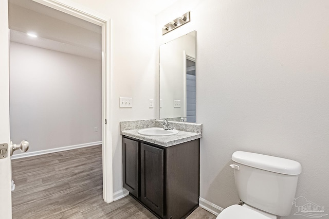 5805 Guinevere Ln, Milton, FL 32583 - half bath featuring toilet, vanity, wood finished floors, and baseboards
