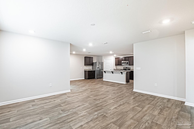5805 Guinevere Ln, Milton, FL 32583 - unfurnished living room with light wood-style floors, recessed lighting, and baseboards