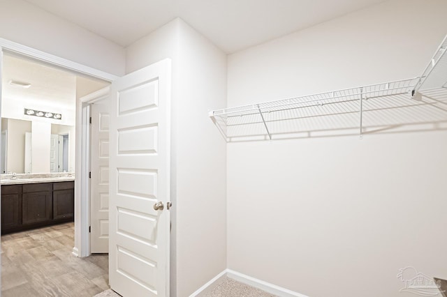 5805 Guinevere Ln, Milton, FL 32583 - spacious closet with a sink and light wood-style floors