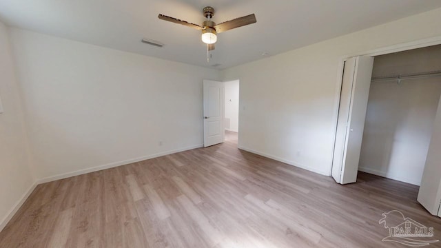 unfurnished bedroom with visible vents, baseboards, a closet, and light wood finished floors