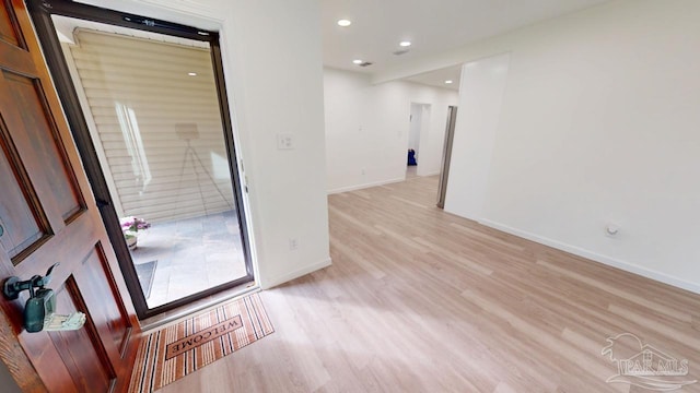 empty room with recessed lighting, baseboards, and light wood-style floors