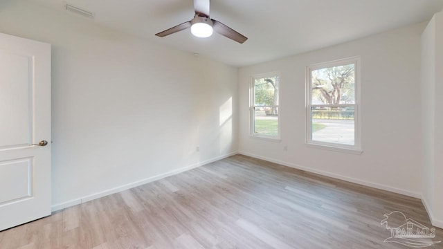 unfurnished room featuring visible vents, baseboards, and light wood-style flooring