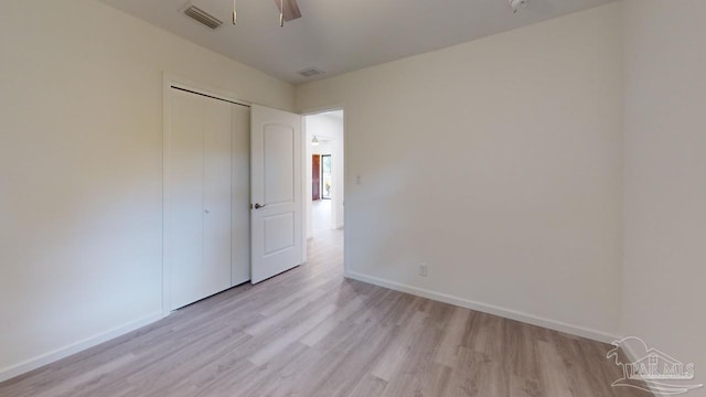 unfurnished bedroom with light wood-type flooring, baseboards, and visible vents