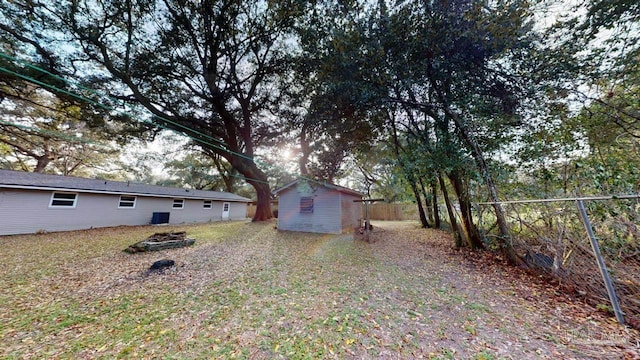 view of yard with an outbuilding and fence