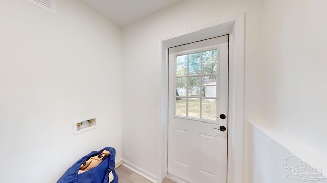 doorway with visible vents and baseboards