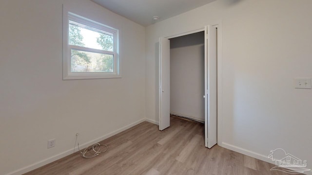 unfurnished bedroom featuring light wood finished floors and baseboards