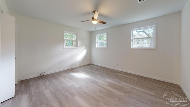 unfurnished room featuring a ceiling fan, wood finished floors, and baseboards