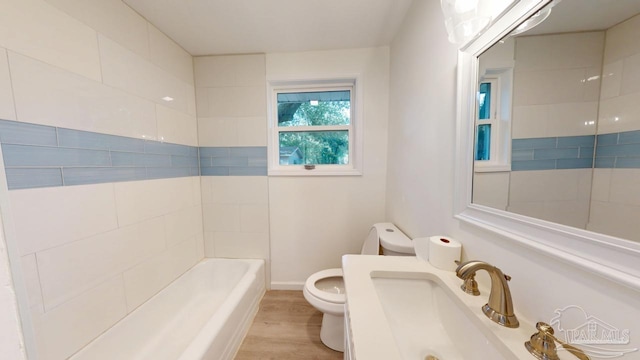 full bathroom featuring toilet, wood finished floors, a bathtub, and a shower