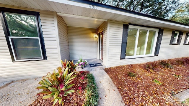 view of exterior entry with a porch