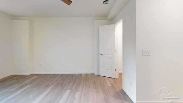 unfurnished room with light wood-type flooring, baseboards, visible vents, and a ceiling fan