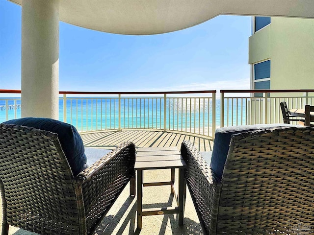 balcony with a view of the beach and a water view