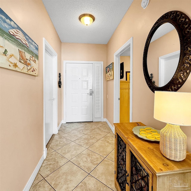 tiled foyer entrance with a textured ceiling