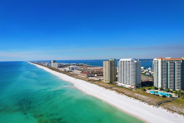 birds eye view of property featuring a water view and a beach view