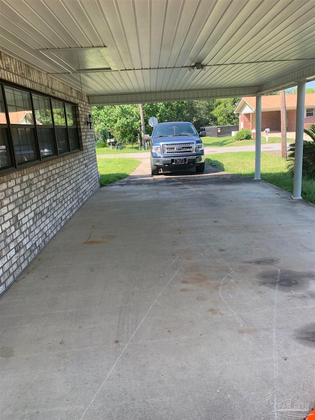 exterior space with a lawn and a carport