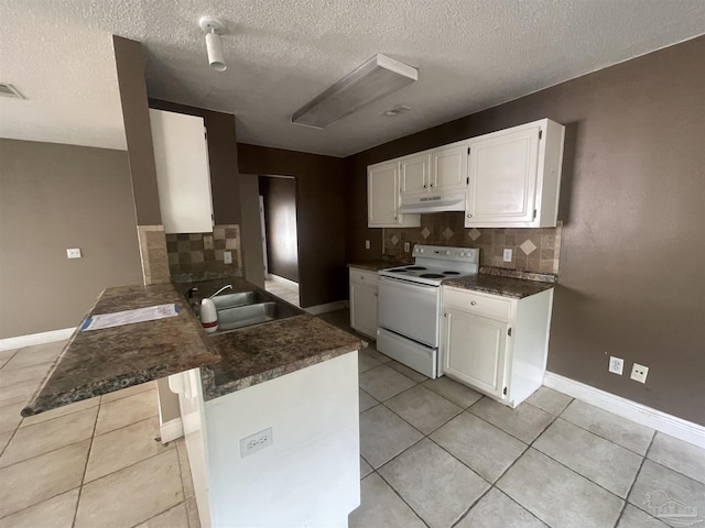 kitchen featuring dark countertops, under cabinet range hood, white cabinetry, and white range with electric cooktop