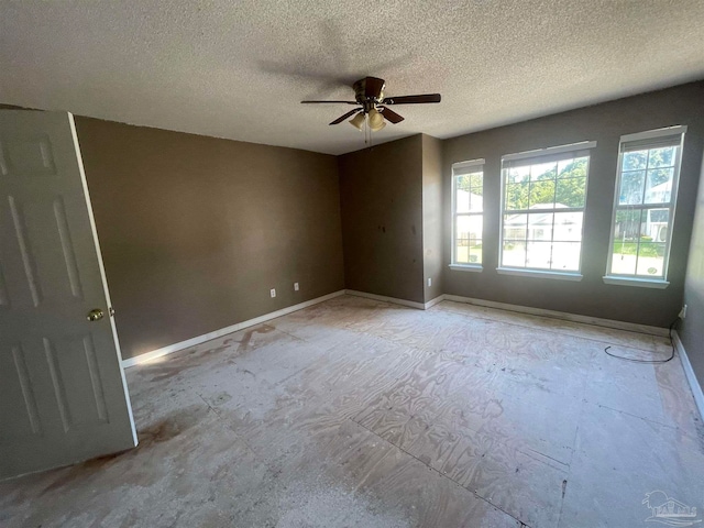 unfurnished room with a textured ceiling and ceiling fan