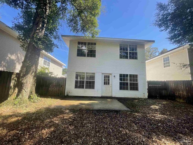 back of property with a patio