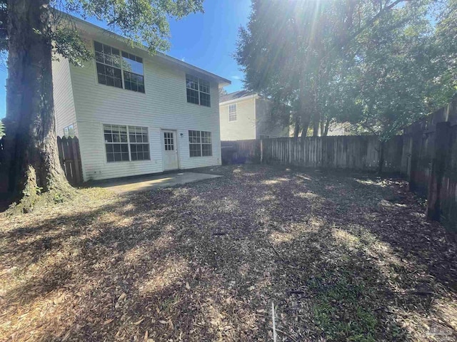 back of property featuring a patio area and a fenced backyard