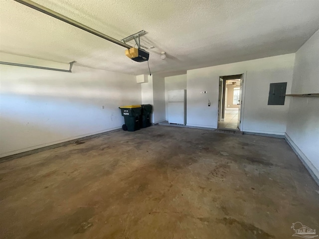 garage featuring electric panel, white refrigerator, and a garage door opener