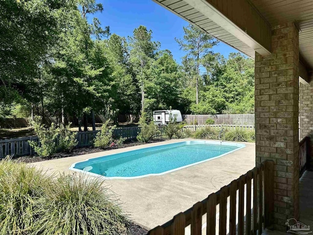 view of pool featuring a fenced in pool, a fenced backyard, and a patio area