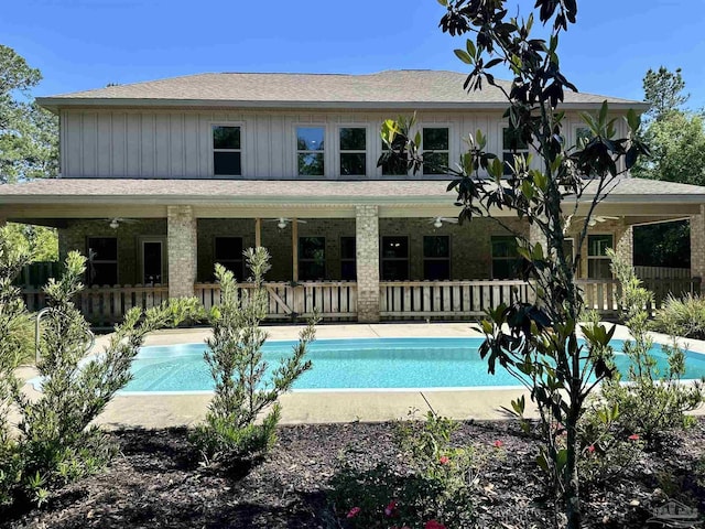 outdoor pool featuring fence