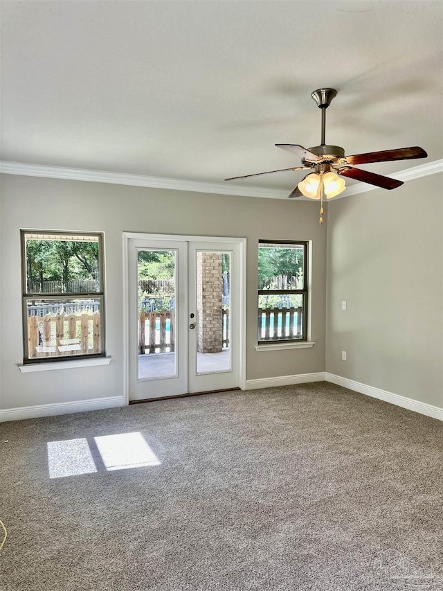 unfurnished room featuring crown molding, carpet flooring, french doors, and a wealth of natural light