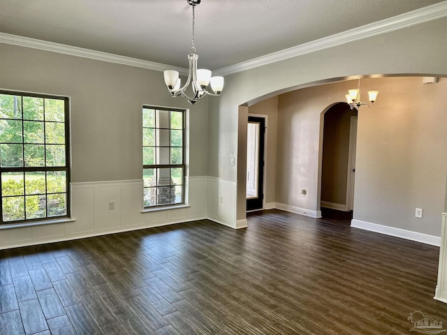 unfurnished room with arched walkways, dark wood-style flooring, and a chandelier
