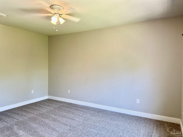 empty room featuring baseboards, ceiling fan, and dark colored carpet