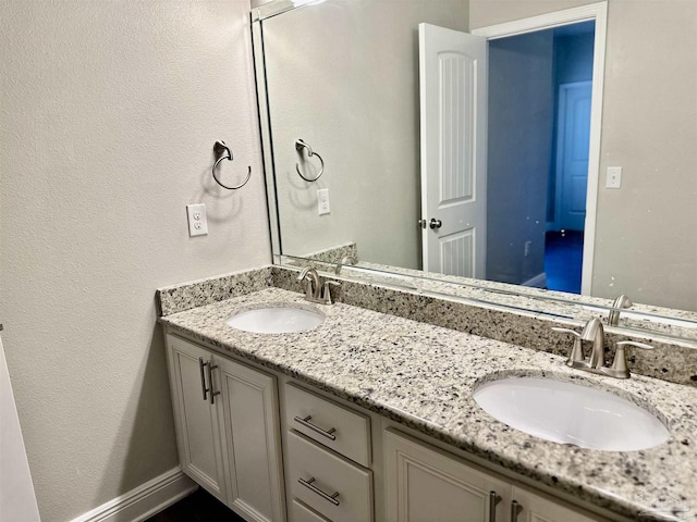bathroom with double vanity and a sink