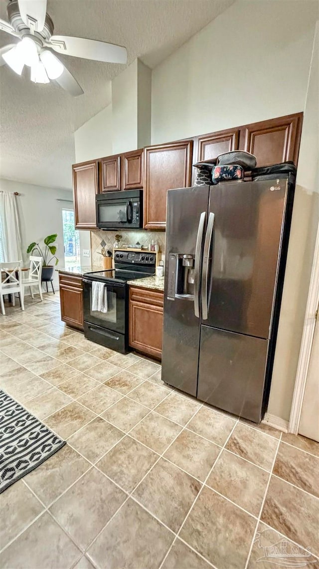 kitchen featuring vaulted ceiling, decorative backsplash, black appliances, a textured ceiling, and ceiling fan