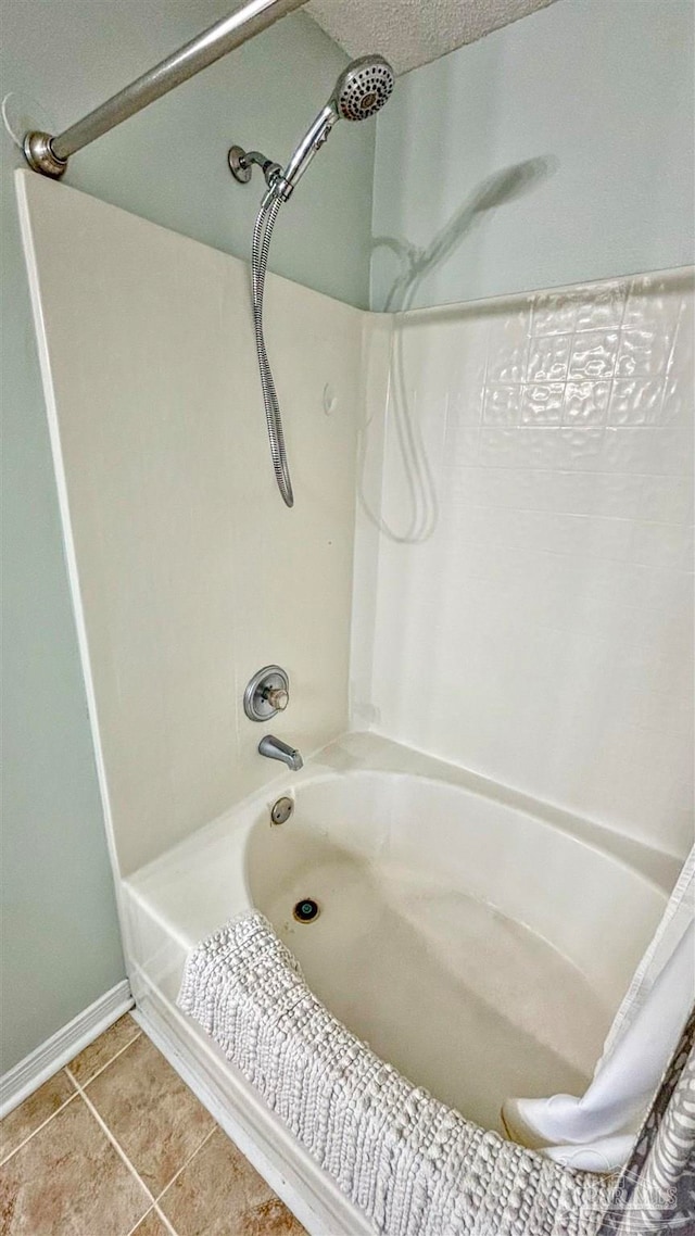 bathroom with shower / bathtub combination with curtain, tile patterned flooring, and a textured ceiling