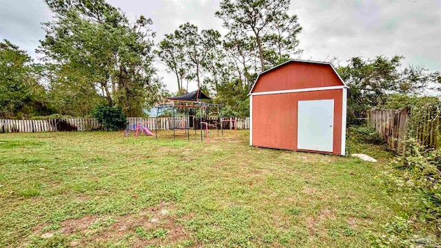 view of yard featuring a playground and a storage unit