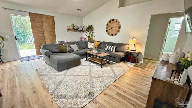 living room with vaulted ceiling and hardwood / wood-style flooring