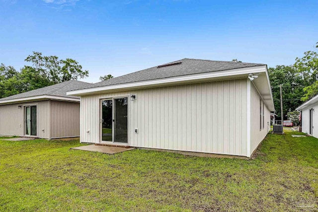 rear view of property featuring a yard